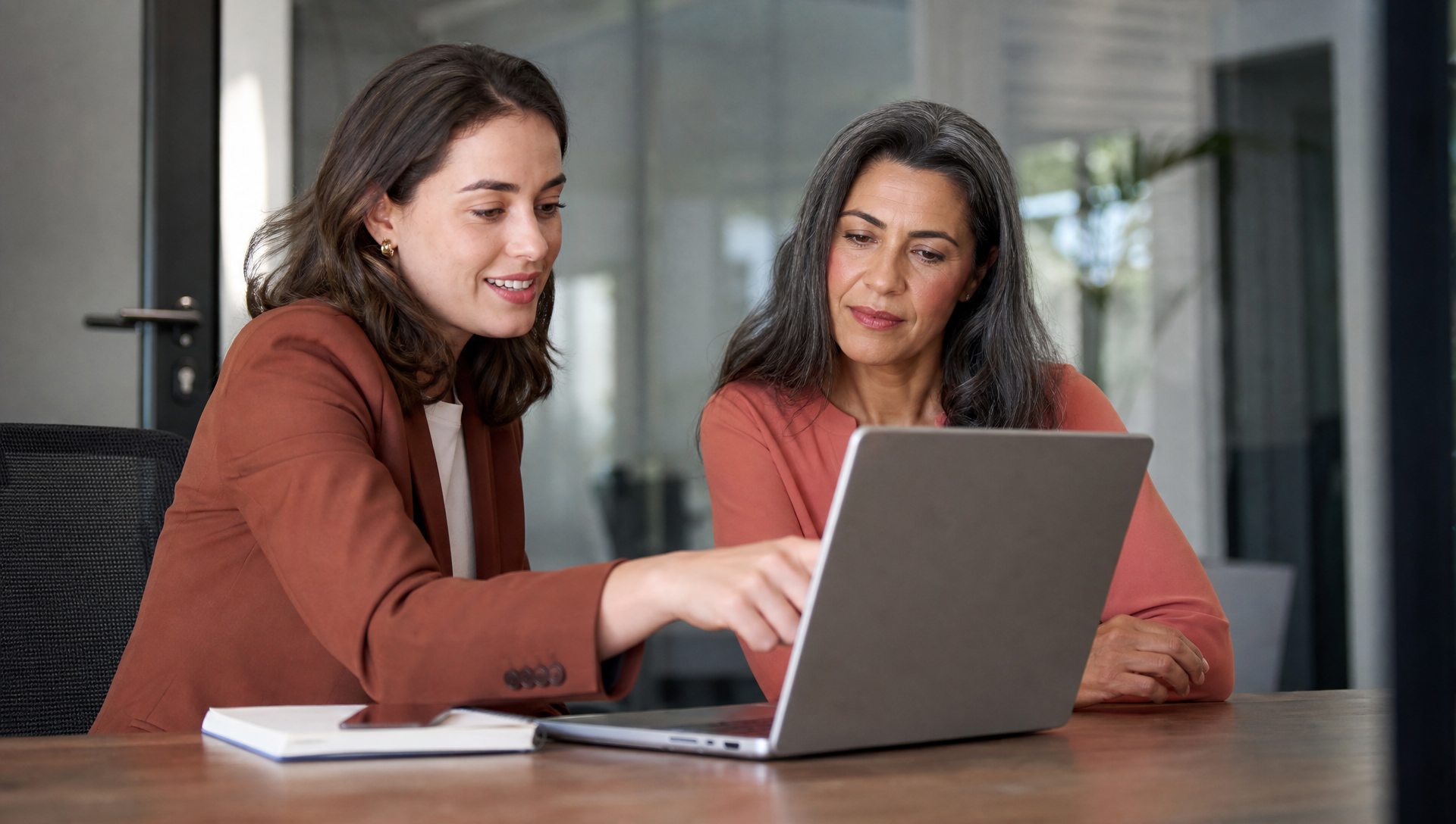 A remote professional working from a home office with a laptop, receiving technology support